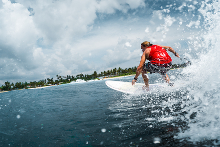 Surfer rides the ocean wave with lots of splashesの写真素材