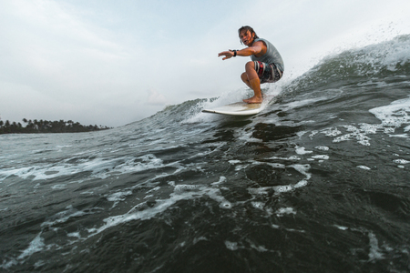 Surfer rides the wave during a dayの写真素材