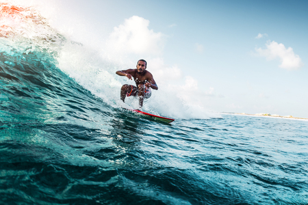 Young surfer rides the wave. Extreme sport and active lifestyle conceptの写真素材