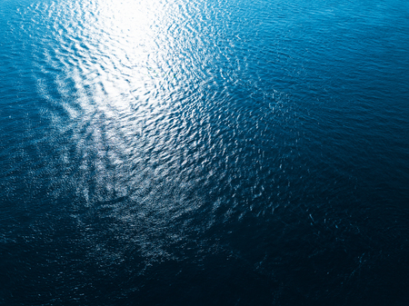 Sea surfase aerial view. Strong sea current is visible on left side of the frame as non regular patternの写真素材