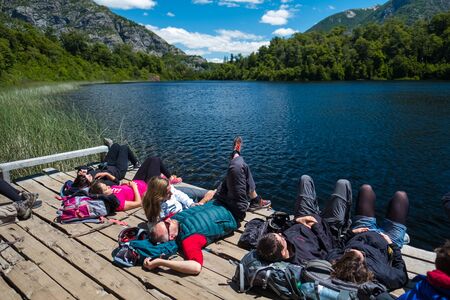 BARILOCHE, ARGENTINA - DECEMBER 30, 2017. Hikers relax near the lake after walking on the trails in National Park of Nahuel Huapiのeditorial素材