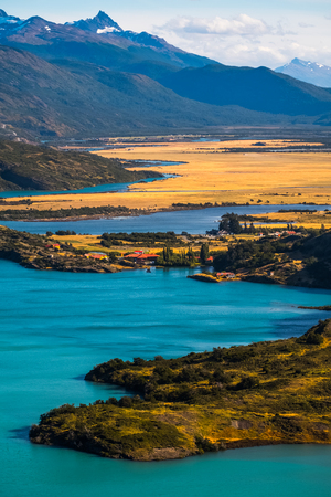 Valley with yellow fields, mountains, blue lakes and rivers. Torres del Paine National Park, Chileの写真素材