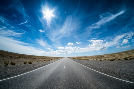 Asphalt road in the desert and sky with clouds. Road 3 (Ruta 3) through the Argentinean pampa.の写真素材