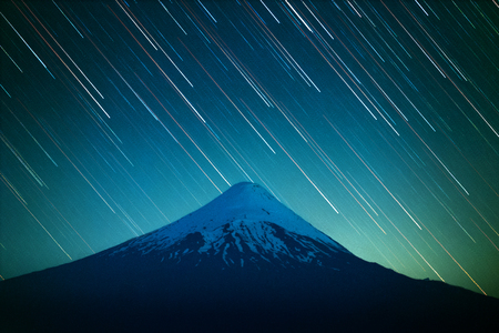 Volcano of Osorno and night sky with star trails. Patagonia, Chileの写真素材