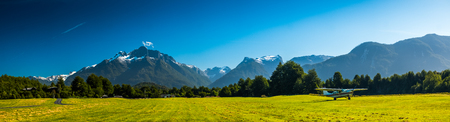 Airport with green grassy runaway in the rural area among the Patagonian mountains, Chileの写真素材