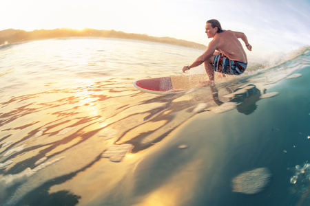 Surfer rides the wave in tropics at sunrise. Costa Ricaの写真素材