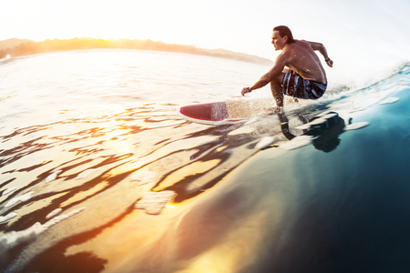 Surfer rides the glassy wave in tropics at sunrise. Costa Ricaの写真素材