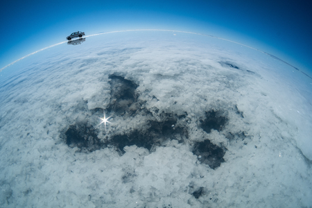 Holes with salty water on the surface of Salar de Uyuni salt flat, Boliviaの写真素材