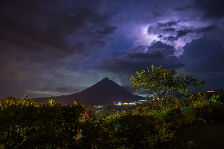 Stormy clouds with lightnings over the volcano of Arenal at night, Costa Ricaの写真素材