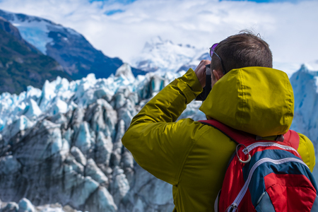 Photographer taking a picture of the ice of glacier. Perito Moreno Glacier, Los Glaciares National Park, Argentinaの写真素材