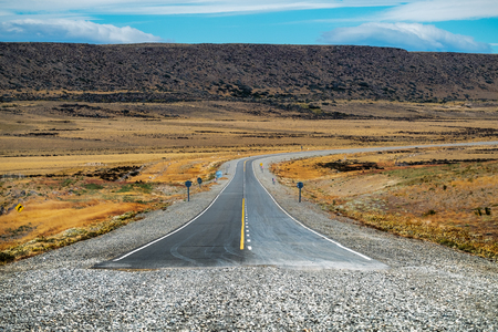 End of the asphalt road named Ruta 40 in Argentinian Patagonia. Asphalt road turns into gravel road on National road Ruta 40, Argentina.の写真素材