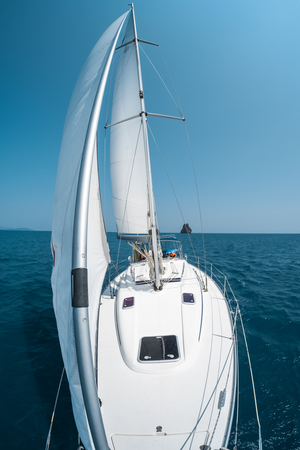Sailing boat moves in a sea, view from the bowの写真素材