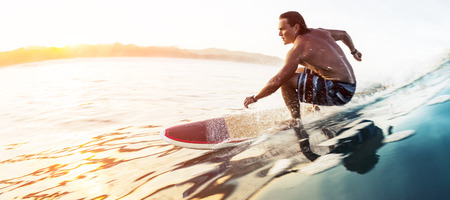 Surfer rides the glassy speedy wave in tropics at sunrise. Costa Ricaの写真素材