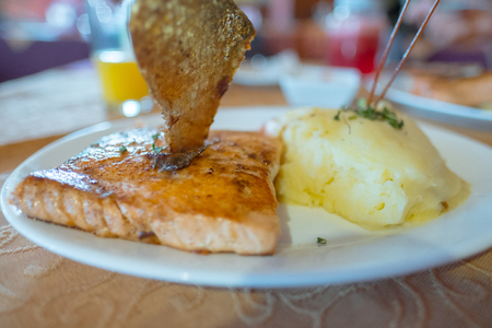 Fried salmon (salmon a la plancha) with mashed potato served in Chilean restaurant.の写真素材