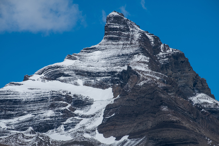 Snow capped mountain with lined patterns, Patagonia, Argentinaの写真素材