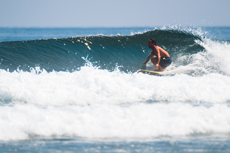 Amateur surfer rides the wave