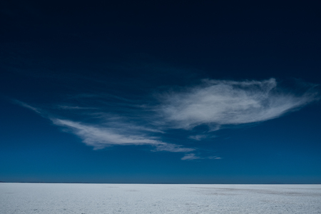 Deep blue sky with fluffy clouds over the Uyuni salt flat, Boliviaの写真素材