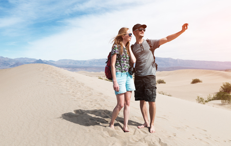 Couple of hikers takes selfie picture being on the sandy desert. The Death Valley, USA.の写真素材