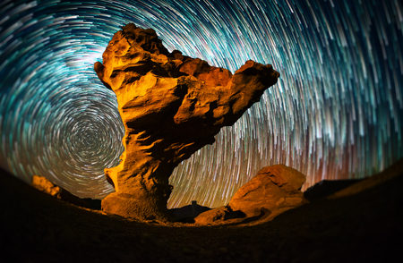 Starry sky with the star trails like comets and rock formation named Arbol de Piedra (Stone Tree) in Eduardo Avaroa Andean Fauna National Reserve of Sur Lipez Province, Bolivia. Tilt shift effect appliedの写真素材