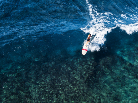 view of the surfer riding the perfect crystal clear wave of Oahu island, Hawaiiの写真素材