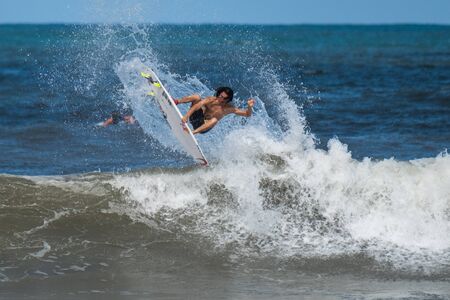OAHU-USA, 09 NOVEMBER 2018: Professional surfer works out before the Vans Triple Crown of Surfing competition and performs complicated trick at Haleiwa beachのeditorial素材