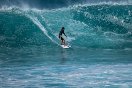 OAHU / USA - 05 DECEMBER 2018: Surfer rides the wave of  the North Shore of Oahu famous for its surfing opportunities.のeditorial素材