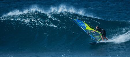 MAUI / USA - 21 DECEMBER 2018: Windsurfer rides ocean wave at Hawaiian Hookipa surf spotのeditorial素材