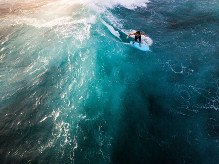 OAHU / USA - 15 NOVEMBER 2018: Surfer rides the ocean tropical wave. Aerial view of Makaha surf spot, west coast of Oahu, Hawaiiのeditorial素材