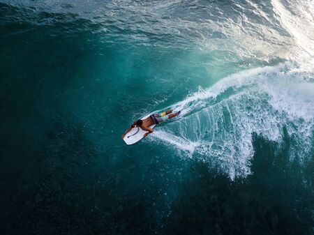 OAHU / USA - 15 NOVEMBER 2018: Surfer rides the ocean tropical wave on bodyboard. Aerial view of Makaha surf spot, west coast of Oahu, Hawaiiのeditorial素材