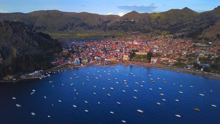 Aerial view of the town of Copacobana and lake Titicaca with the boats anchored in its calm waters. Boliviaの写真素材