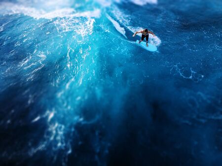 OAHU / USA - 15 NOVEMBER 2018: Surfer rides the ocean tropical wave. Aerial view of Makaha surf spot, west coast of Oahu, Hawaii. Tilt shift effect appliedのeditorial素材