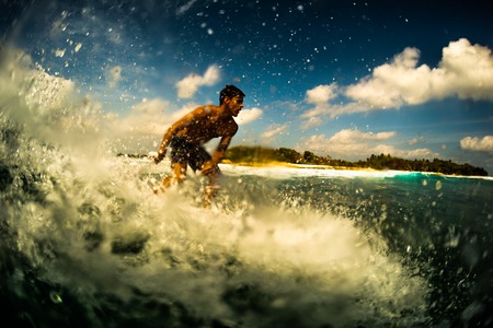Male surfer ride the wave with lots of splashes