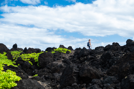 Woman hiker walks on the sharp volcanic land. Maui, Hawaiiの写真素材