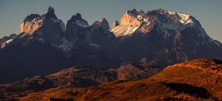 Panoramic shot of the snow and ice capped mountains - Cordillera Paine in Torres del Paine National Park in Chilean Patagonia during sunsetの写真素材