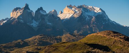 Panoramic shot of the snow and ice capped mountains - Cordillera Paine in Torres del Paine National Park in Chilean Patagonia during sunsetの写真素材