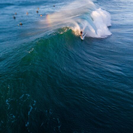 Surfer gets barreled in the wave. Aerial view of the Backdoor surf spot on the North Shore of Oahu in Hawaiiの写真素材