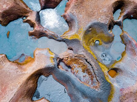 Aerial top down view of the geothermal area named Sol de Manana with sulfur springs and mud lakes in Bolivian Altiplanoの写真素材