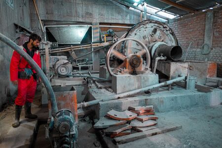 POTOSI / BOLIVIA - APRIL 02, 2018: Tourist watches the process of silver mining in the factory...