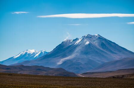 Snow capped mountains in Bolivia during sunny dayの写真素材