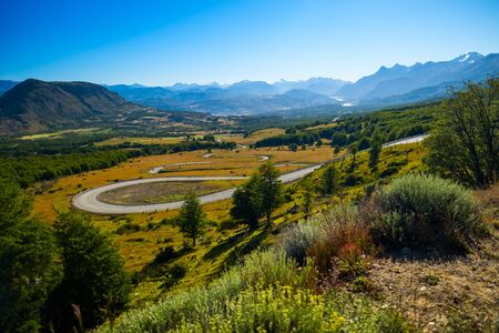 Curved asphalt road named Carretera Austral (Southern Highway) in Chilean Patagonia. Mountain pass near the Cerro Castillo mountainの写真素材