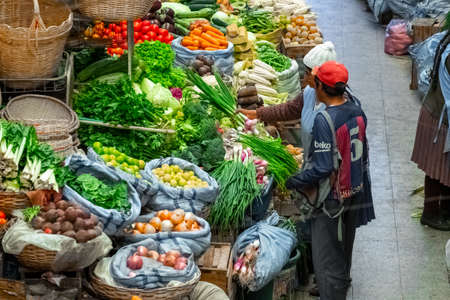 SUCRE / BOLIVIA - APRIL 10, 2018: People buy food on the local market in the city of Sucre in Bolivia full of hand made products and fresh vegetablesのeditorial素材