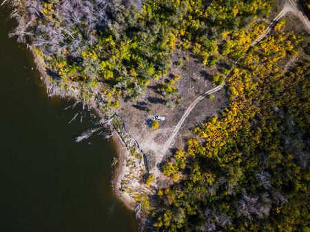 Aerial downward view of the river of Volga and its coast with forest near the town of Akhtubinsk, Russiaの写真素材