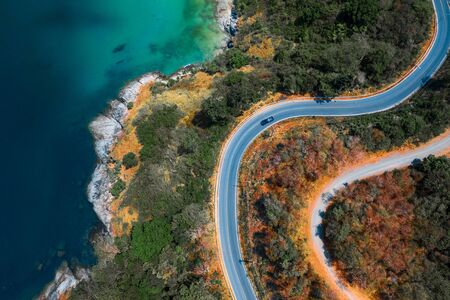 Aerial top down view of the asphalt road on the tropical coastline on Phuket island in Thailandの写真素材