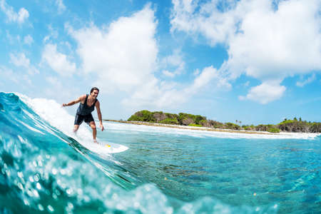 HURAA , MALDIVES MARCH 10, 2019: Hispanic young man surfs the wave on the Sultans surf spot in Maldivesのeditorial素材