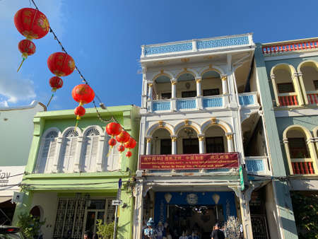 PHUKET TOWN , THAILAND, FEBRUARY 13, 2020: Decorated street with ancient buildings in the Phuketâs Old Town. One building has the supportive banner for Wuhan people saying âChina, Wuhan be strong. You will never walk aloneâのeditorial素材