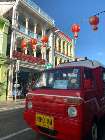 PHUKET TOWN , THAILAND, FEBRUARY 13, 2020: Decorated street with ancient buildings and tuk tuk in the PhuketÃ¢ÂÂs Old Town. One building has the supportive banner for Wuhan people saying "China, Wuhan be strong. You will never walk alone"Âのeditorial素材
