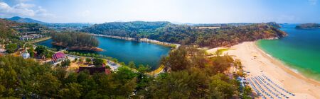 Aerial panorama of the tropical beach of Nai Harn and lake with temple during sunny day, Phuket island, Thailandの写真素材