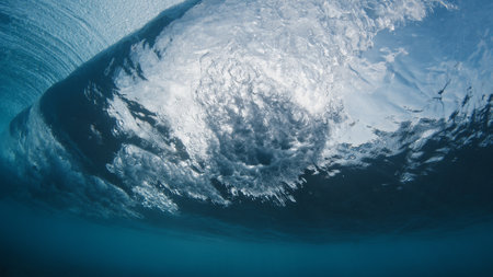Underwater view of the ocean wave breaking on the shore in the Maldivesの写真素材