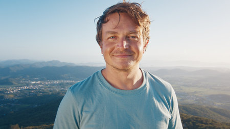 Portrait of the young happy smiling man. Young caucasian man outdoor at sunriseの写真素材