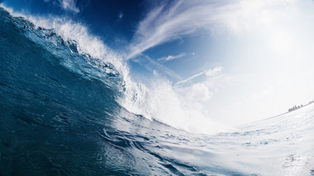Crystal clear ocean wave breaks on the shore in the Maldivesの写真素材
